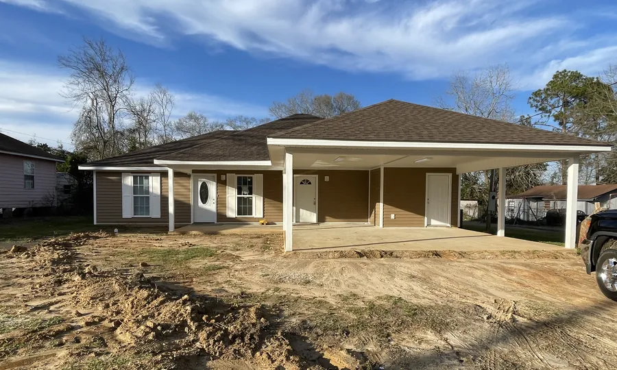 Newly built single-story home with a wide covered carport in Laurel, Mississippi