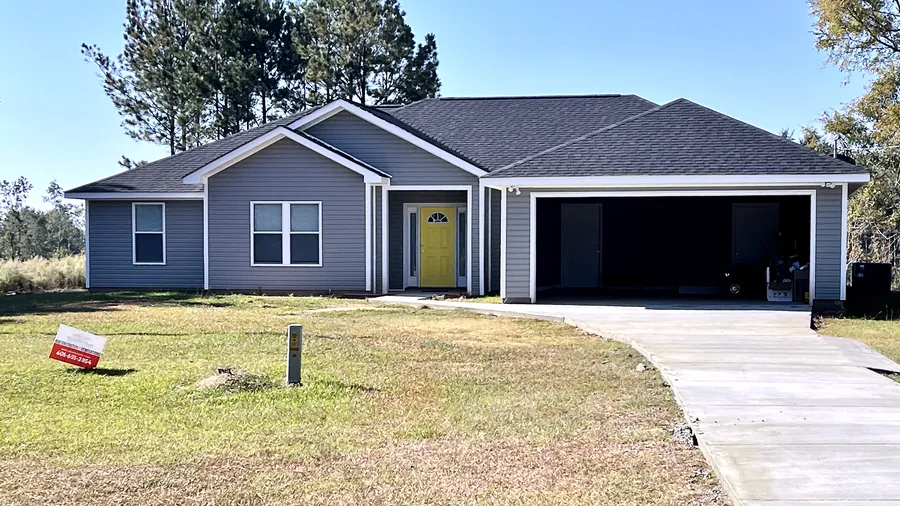 Gray-sided ranch home with a yellow front door and a two-car garage